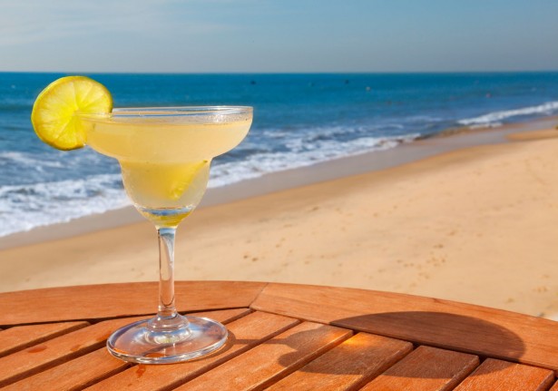 20973079 - daiquiri cocktail with ice on the table against the background of sea and sky