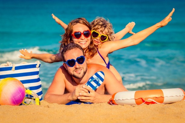 happy family playing at the beach. summer vacation concept