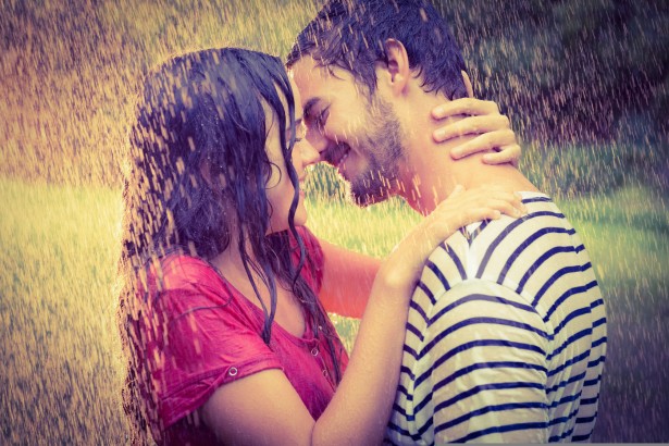 cute couple hugging under the rain in the park