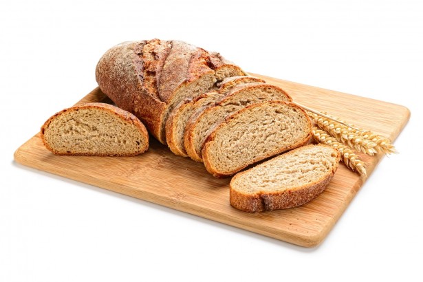 45325668 - fresh sliced bread and wheat on wooden board isolated on white