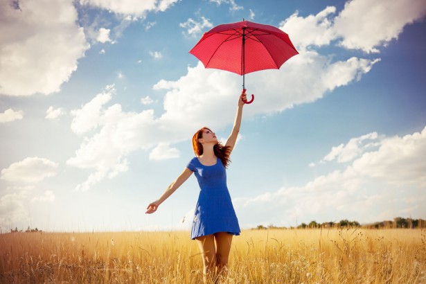 45604899 - beautiful redhead girl with umbrella at autumn countryside