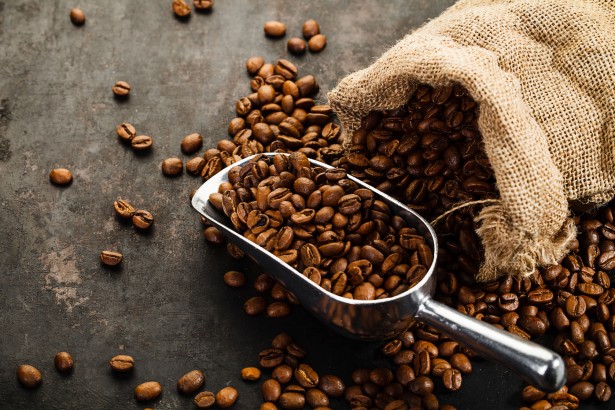 47009229 - cup of coffee, bag and scoop on old rusty background